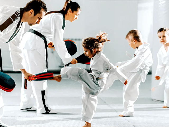 philosophy of Hapkido is shown here with a family learning hapkido dressed in their robes on a mat